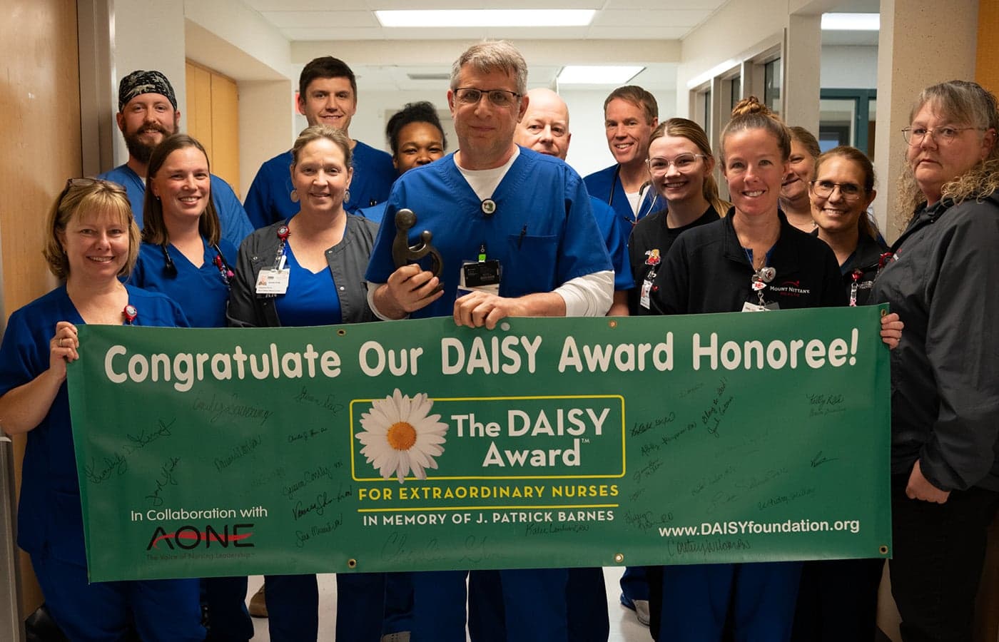 DAISY Award Winner Kevin Schmader poses for a group photo with his colleagues
